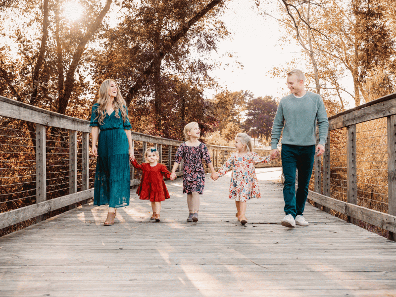 family walking along a bridge